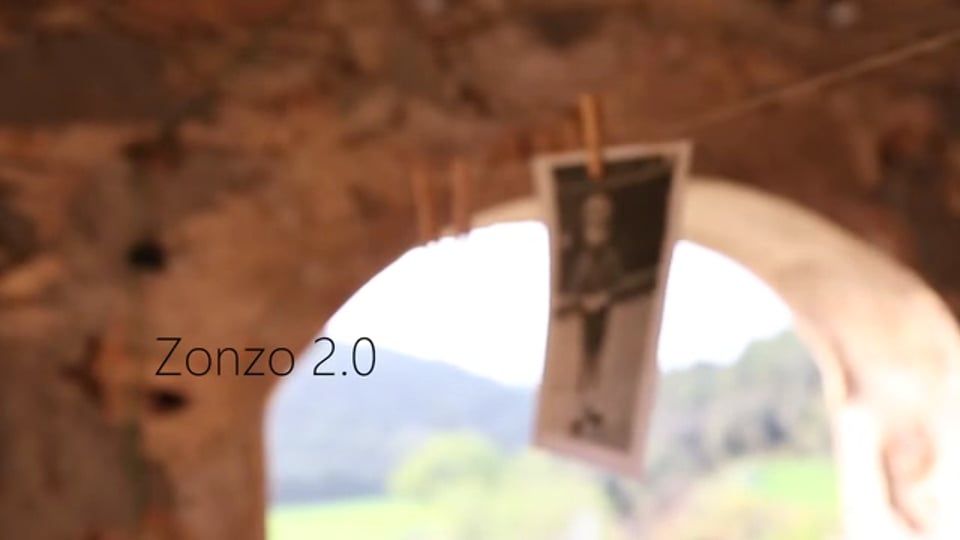 Still from Zonzo 2.0: a photograph pinned to a line in a stone doorway